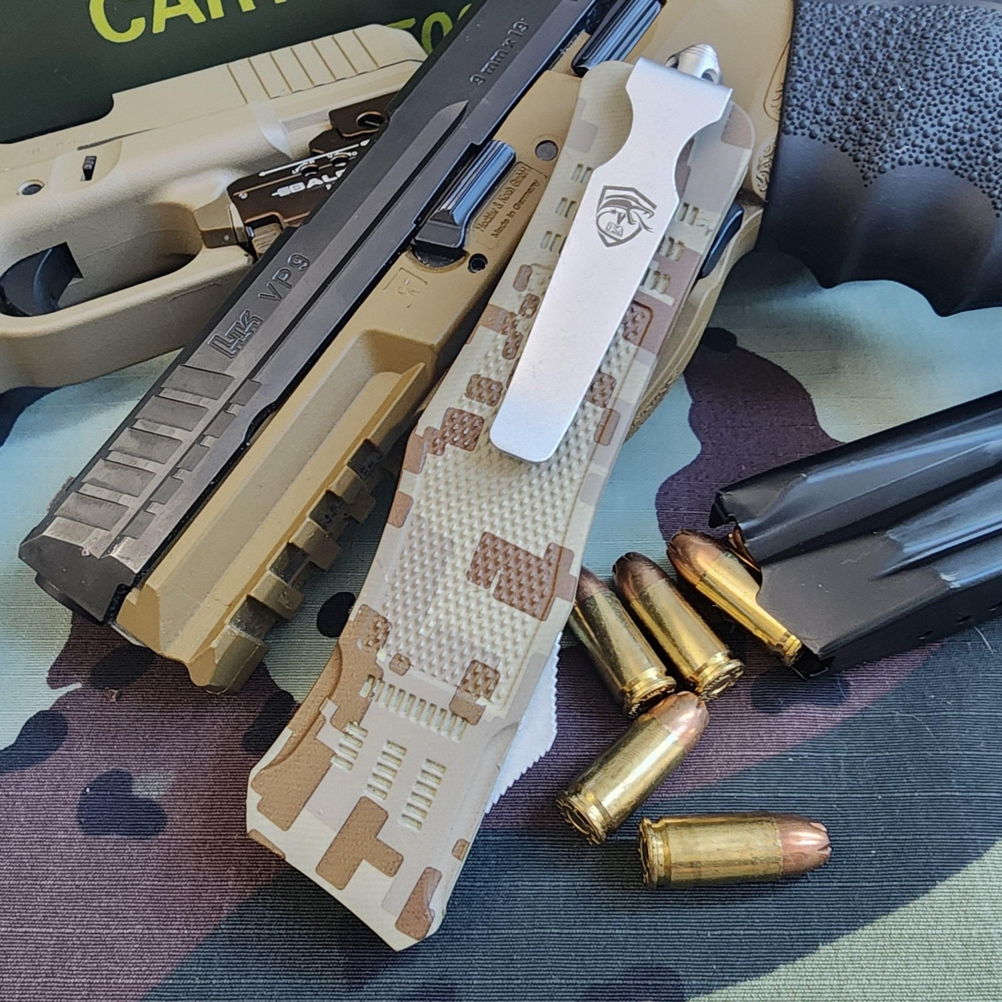 Camouflage knife with bullets on a camouflage-patterned surface
