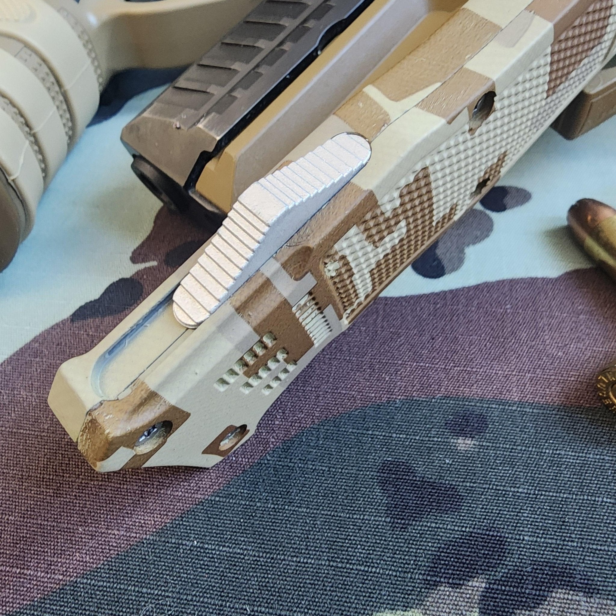 Camouflage-patterned knife on a textured surface