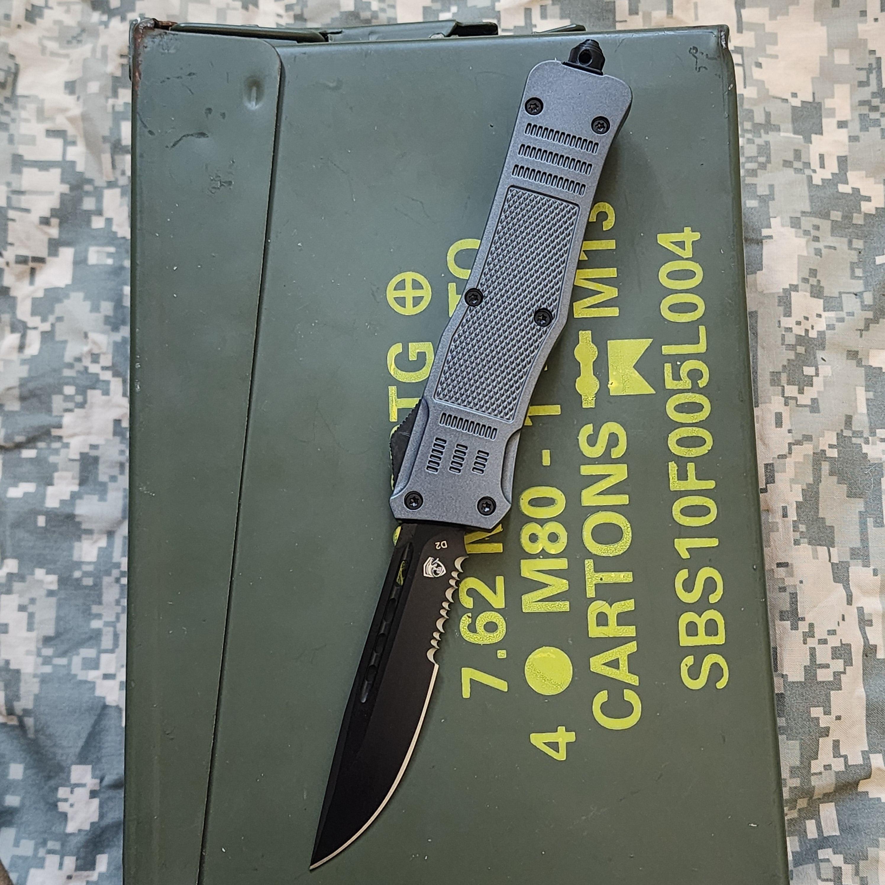 Folding knife on a green ammunition box with yellow text