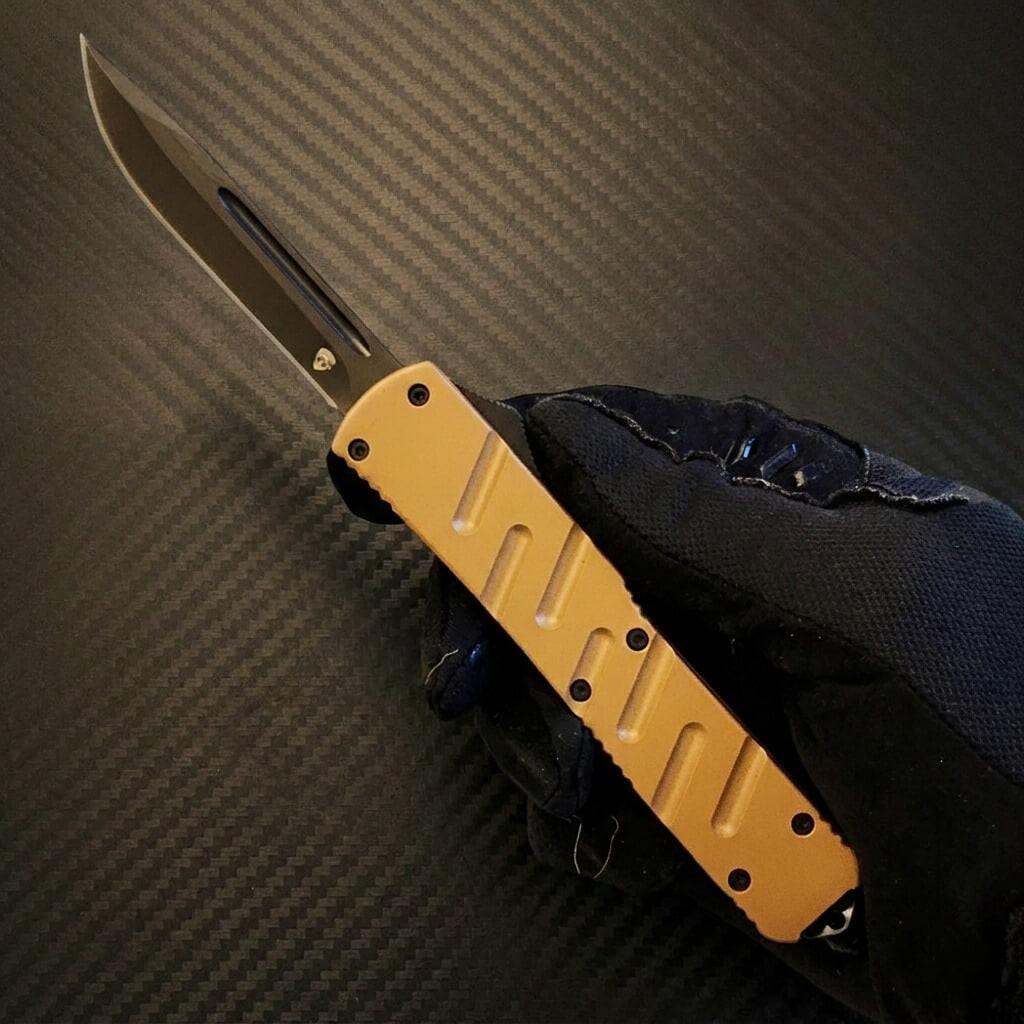 Venom X3 Nighthawk D/A Auto OTF Knife in elegant tan and black, showcasing sleek design and superior durability