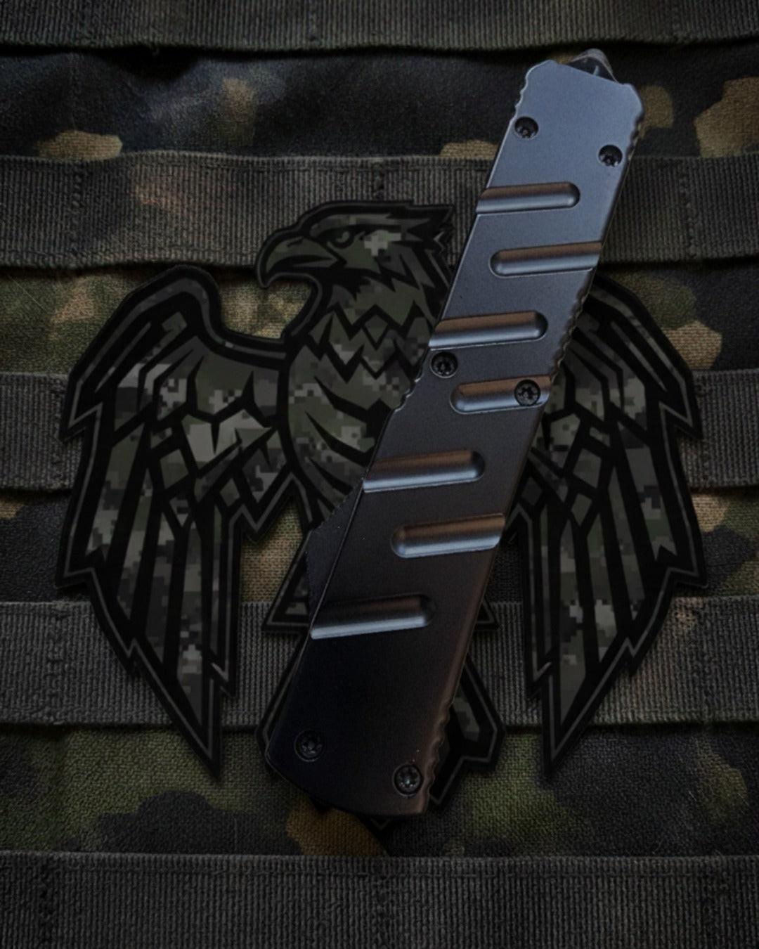 OTF knife with a black eagle design on a camouflage background