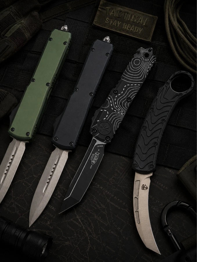 All OTF Knives for Sale - A Group of different style Out the Front Knives  on a tactical themed background