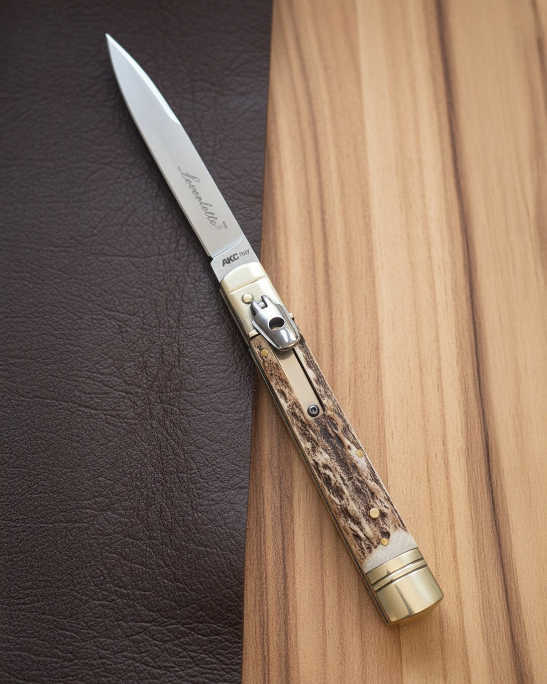 AKC Leverlock Knife with Stag Handle on a Wood Table