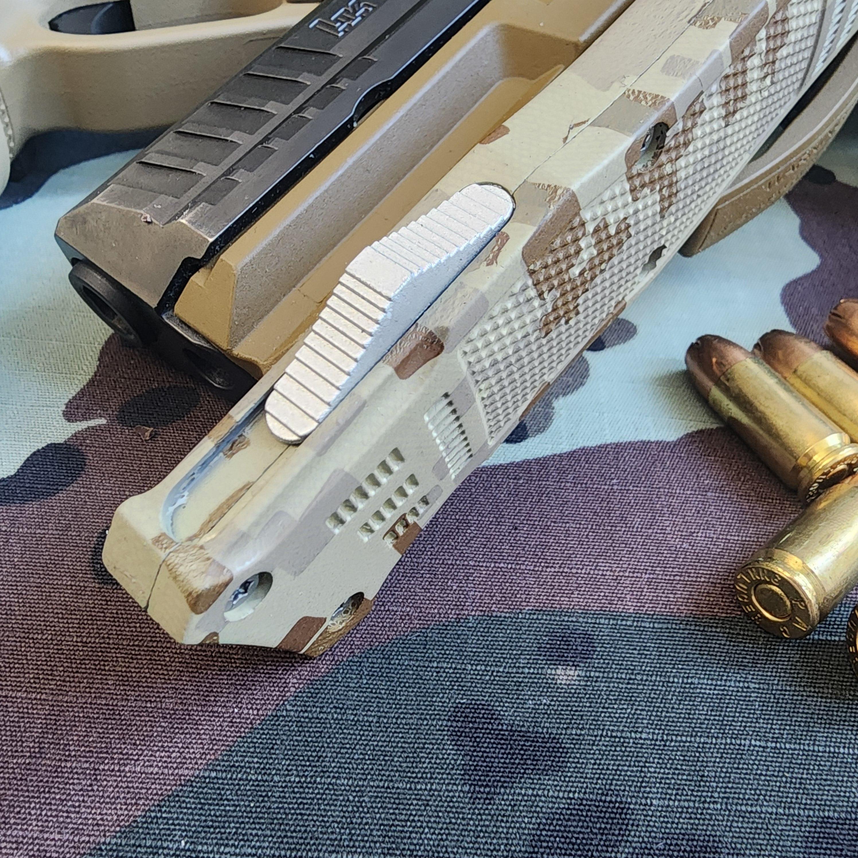 Close-up of a camouflaged firearm and bullets on a camouflage-patterned surface