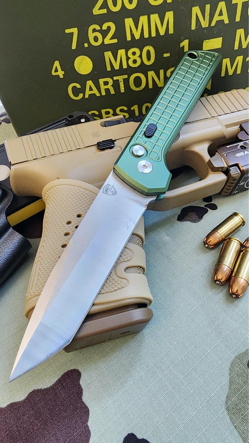 Folding knife with green handle on a camouflage surface with ammunition and firearm in the background