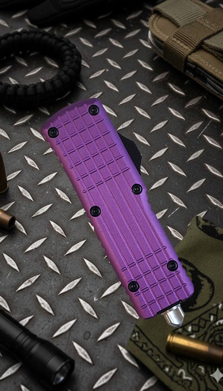 Purple knife with a textured handle on a metallic surface