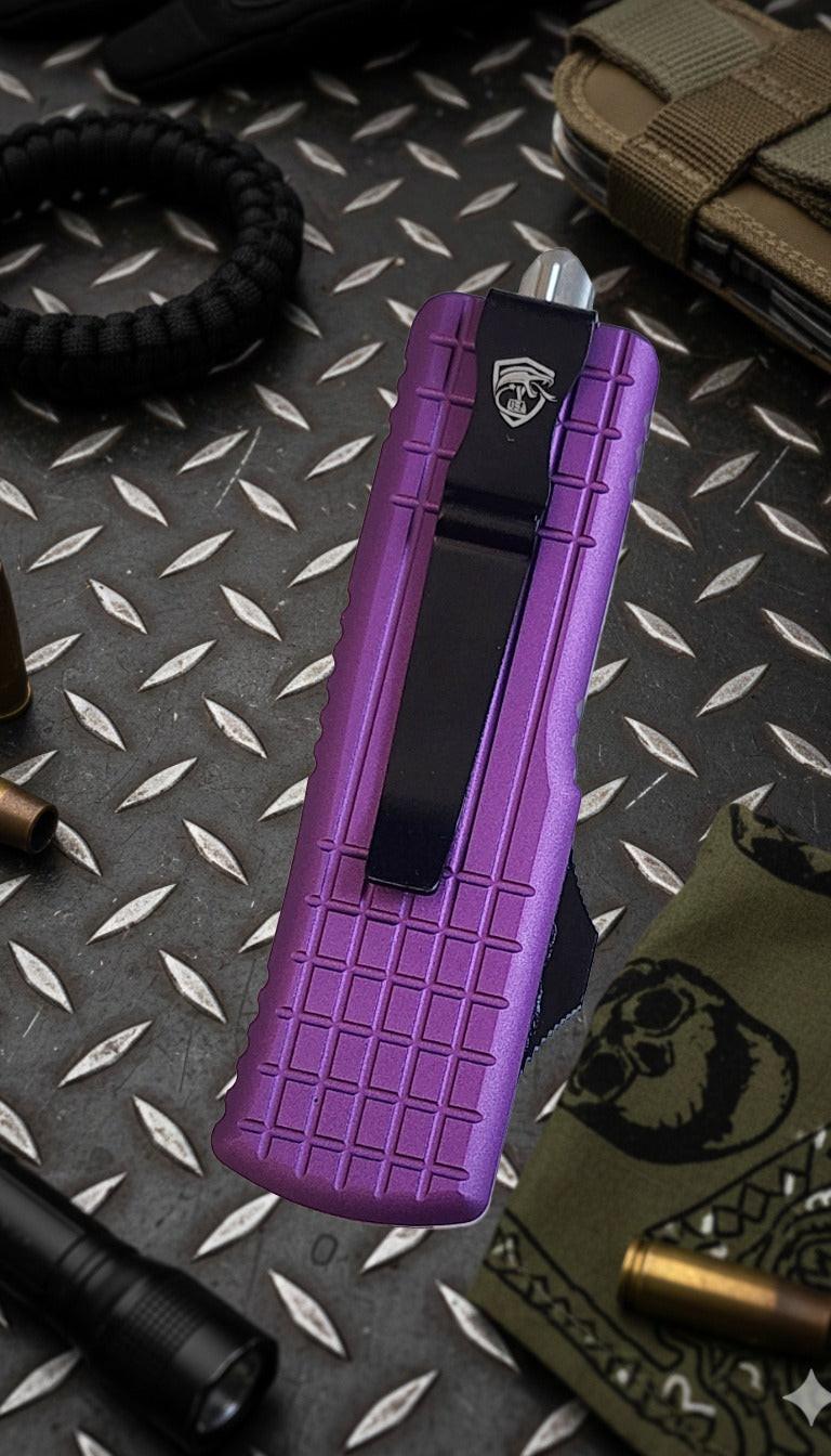 Purple knife sheath on a textured surface with tactical gear.