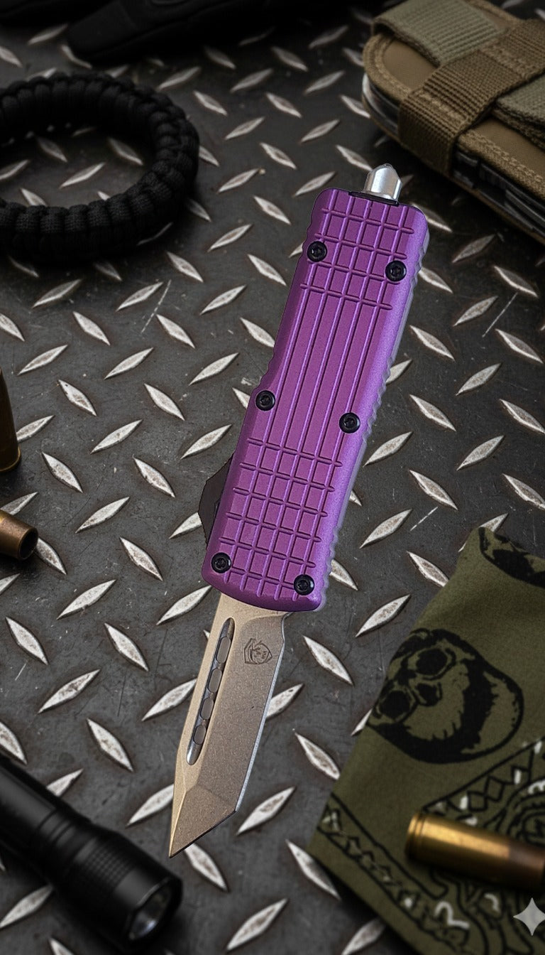 Purple folding knife on a textured surface with tactical gear.