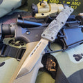 Knife with tactical sheath on a rifle with scope and camouflage background