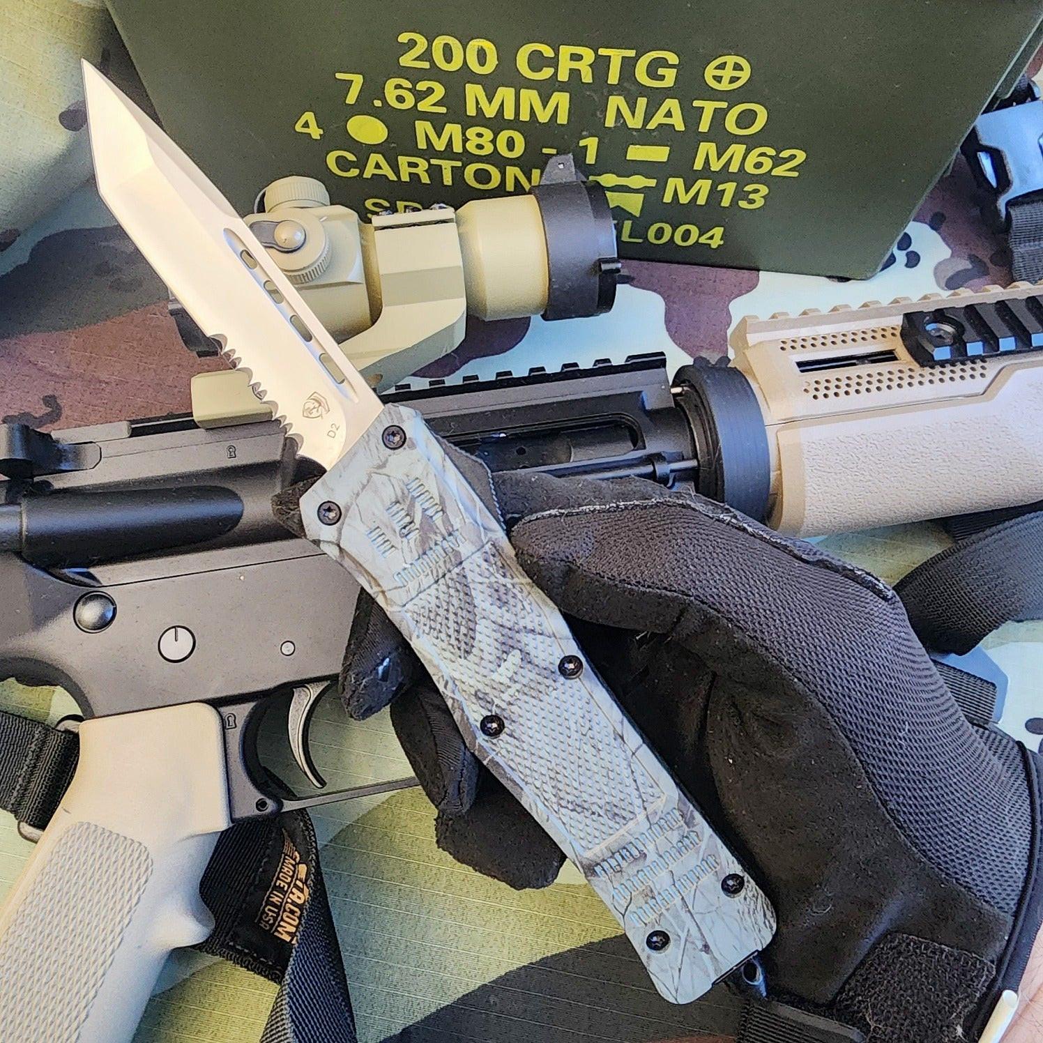 Folding knife held by a gloved hand with a rifle and tactical gear in the background