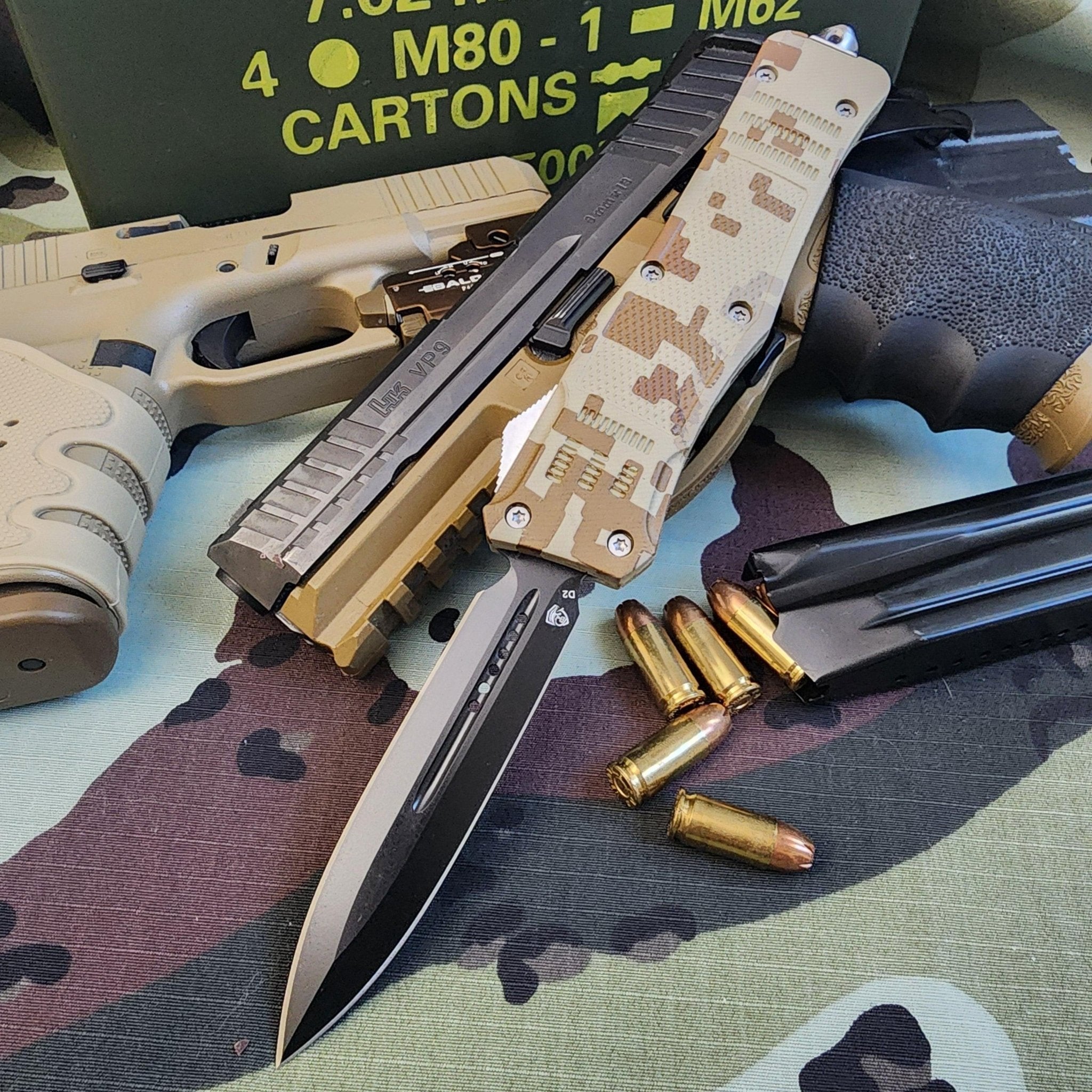 Folding knife with camouflage handle, gun, and ammunition on a camouflage surface