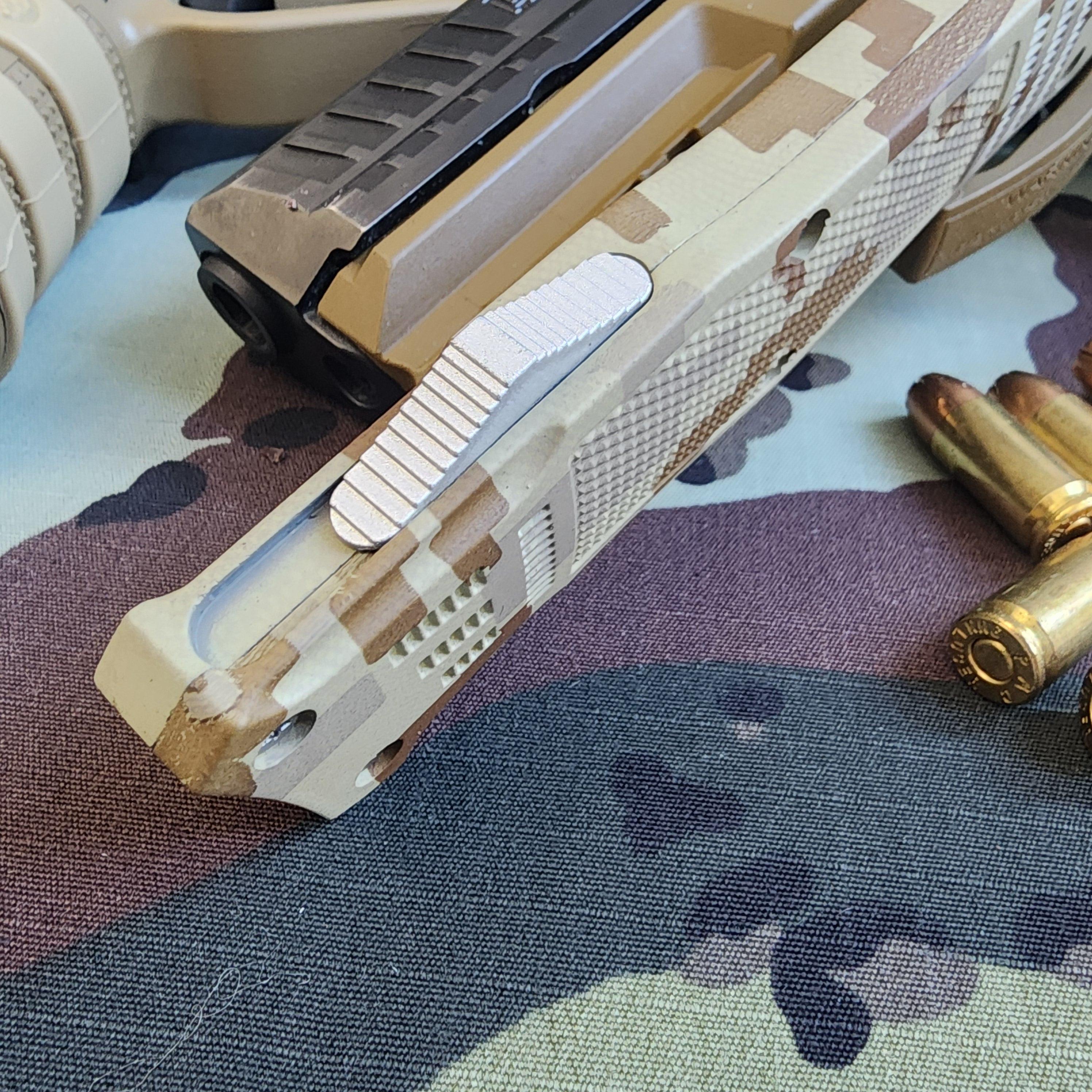 Close-up of a camouflage-patterned handgun with bullets on a camouflage surface
