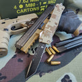 Tactical OTF knife, ammunition, and tactical equipment on a camouflage surface
