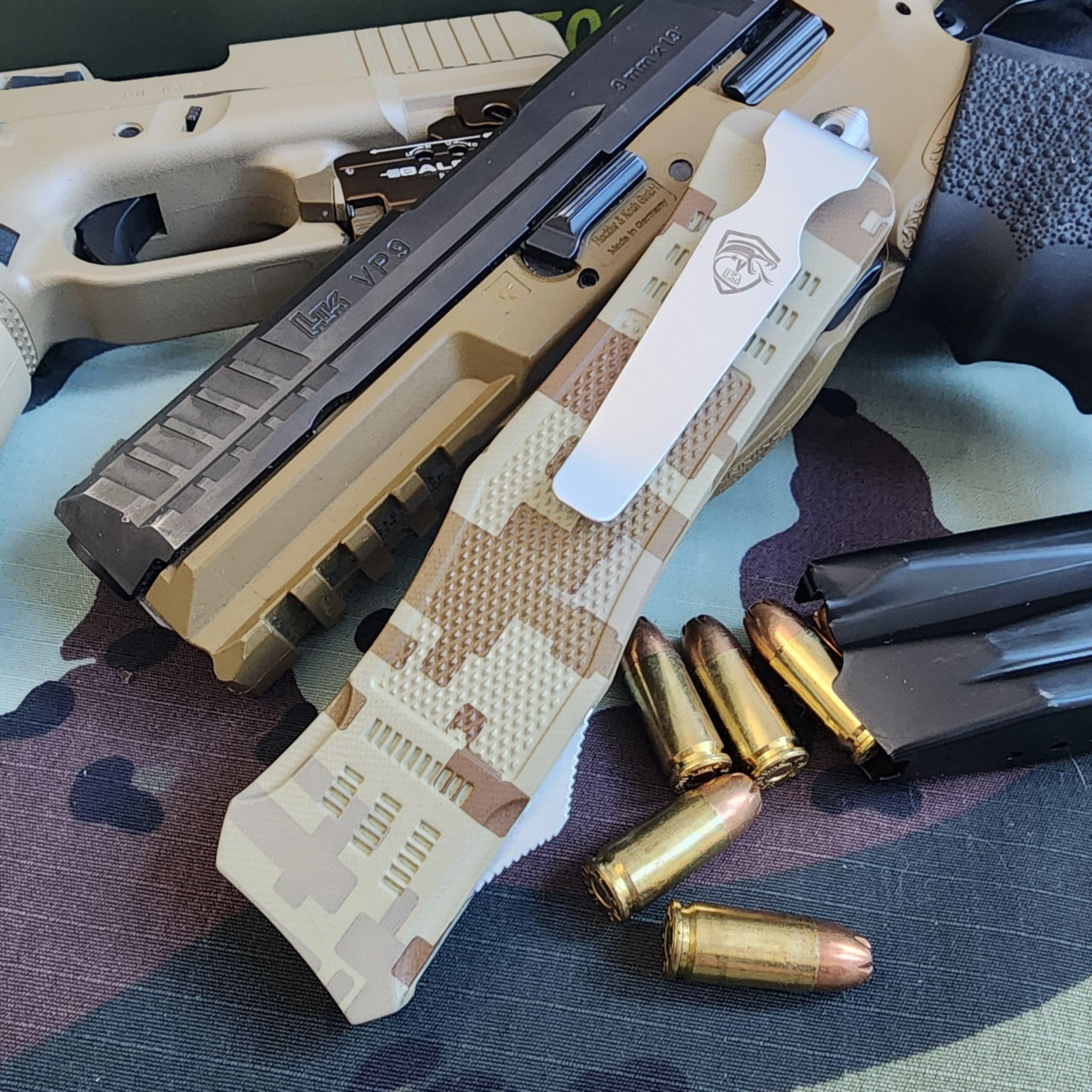 Camouflage handgun with bullets on a camouflage surface