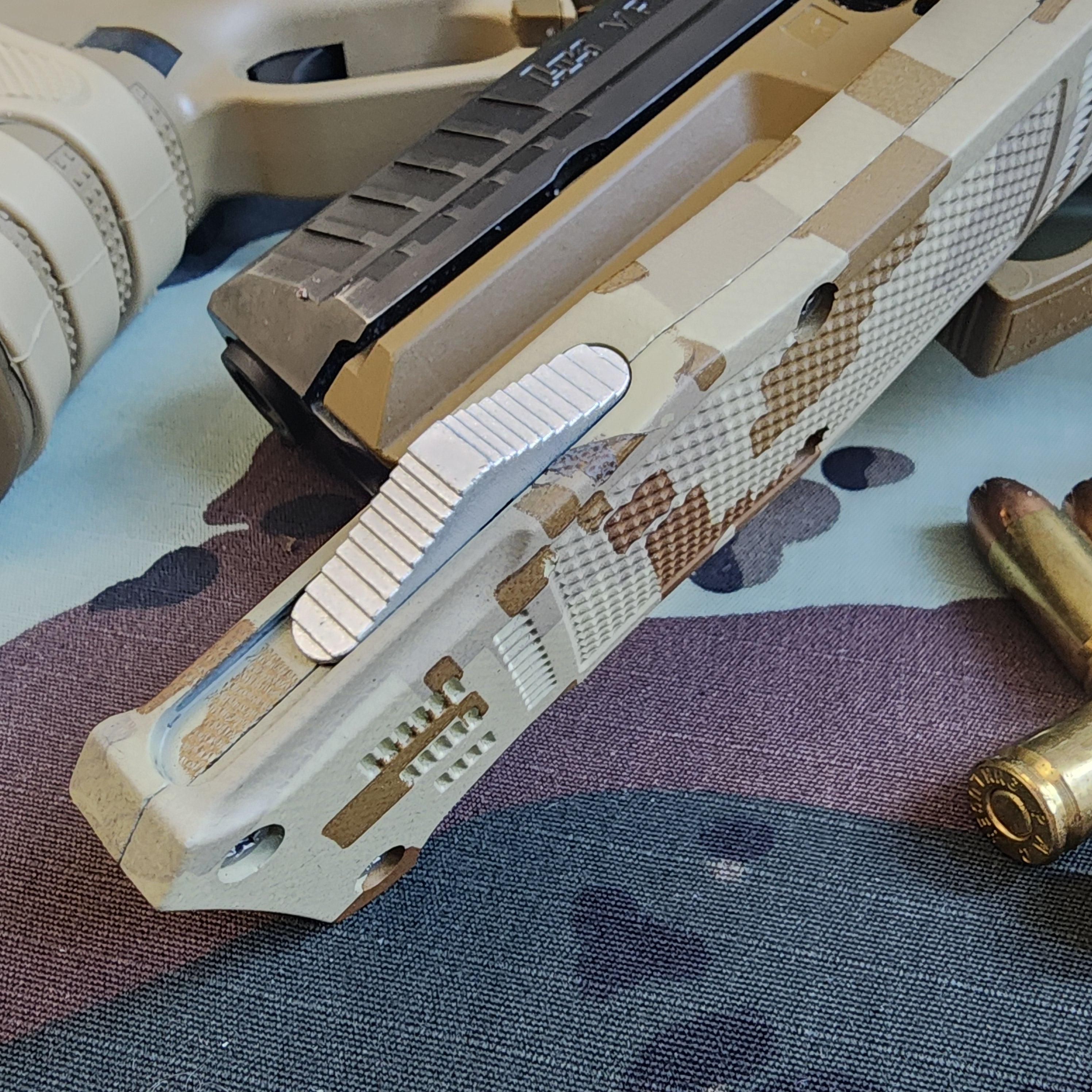 Close-up of a camouflage-patterned knife blade with a textured handle on a fabric background.