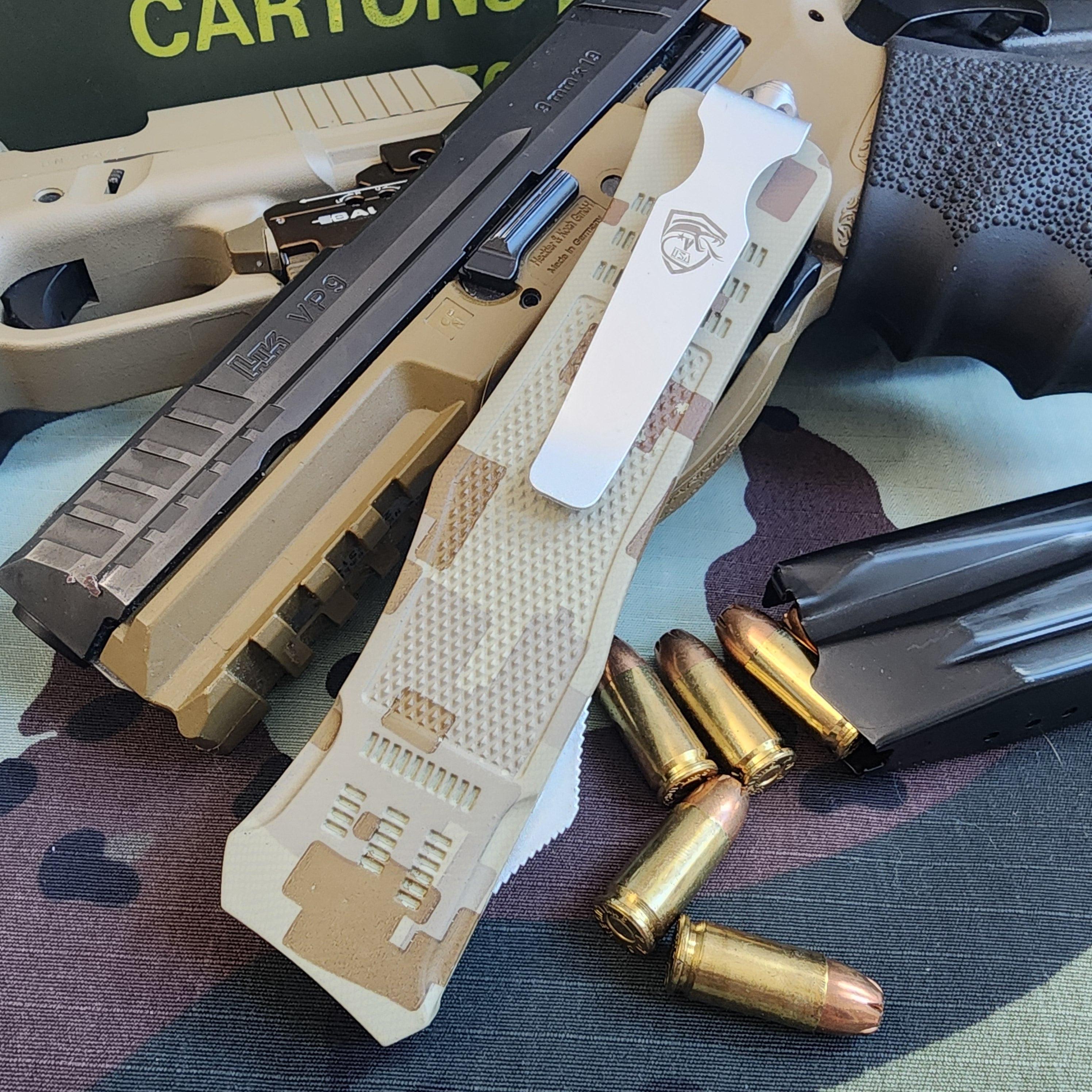 Tan and black firearm with magazine and bullets on a camouflage surface