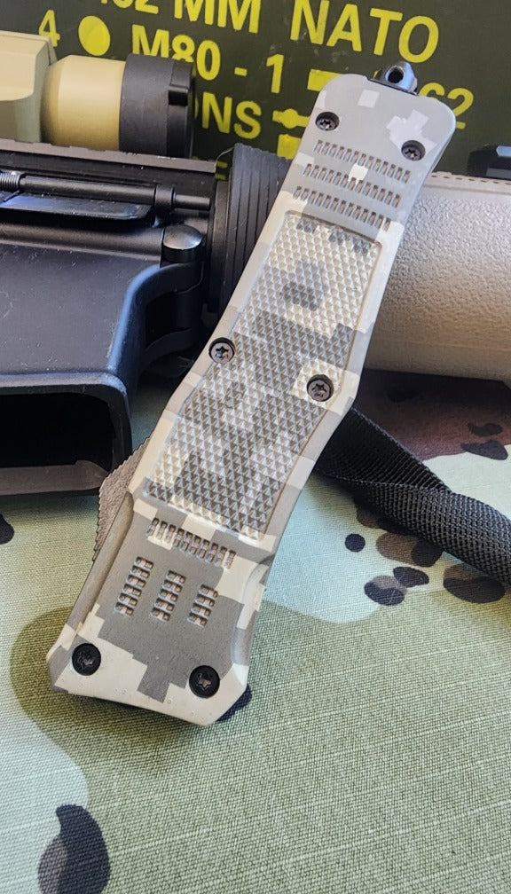 Tactical knife with camouflage pattern on a camouflage surface