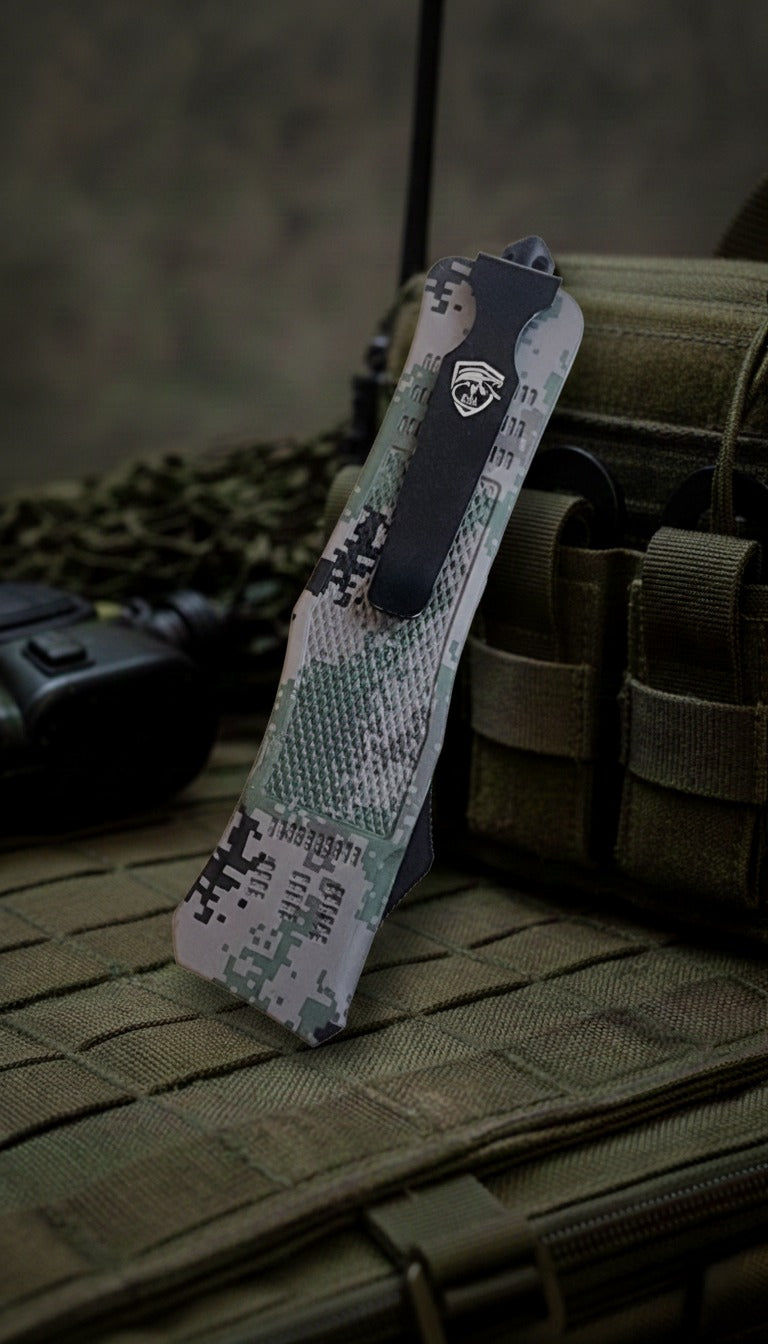 Camouflage-patterned knife sheath on a tactical pouch with a blurred background