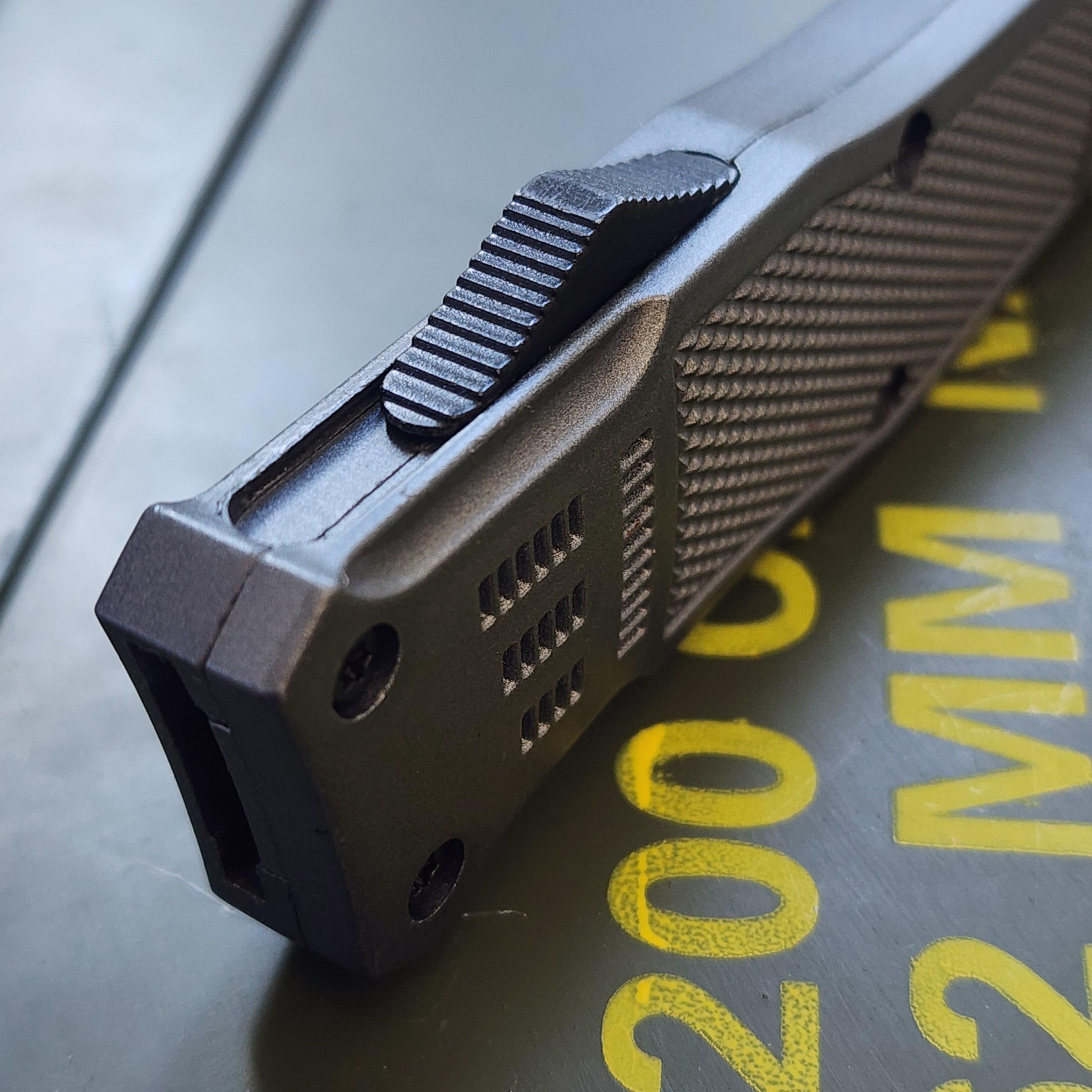 Close-up of a gun slide with text in the background