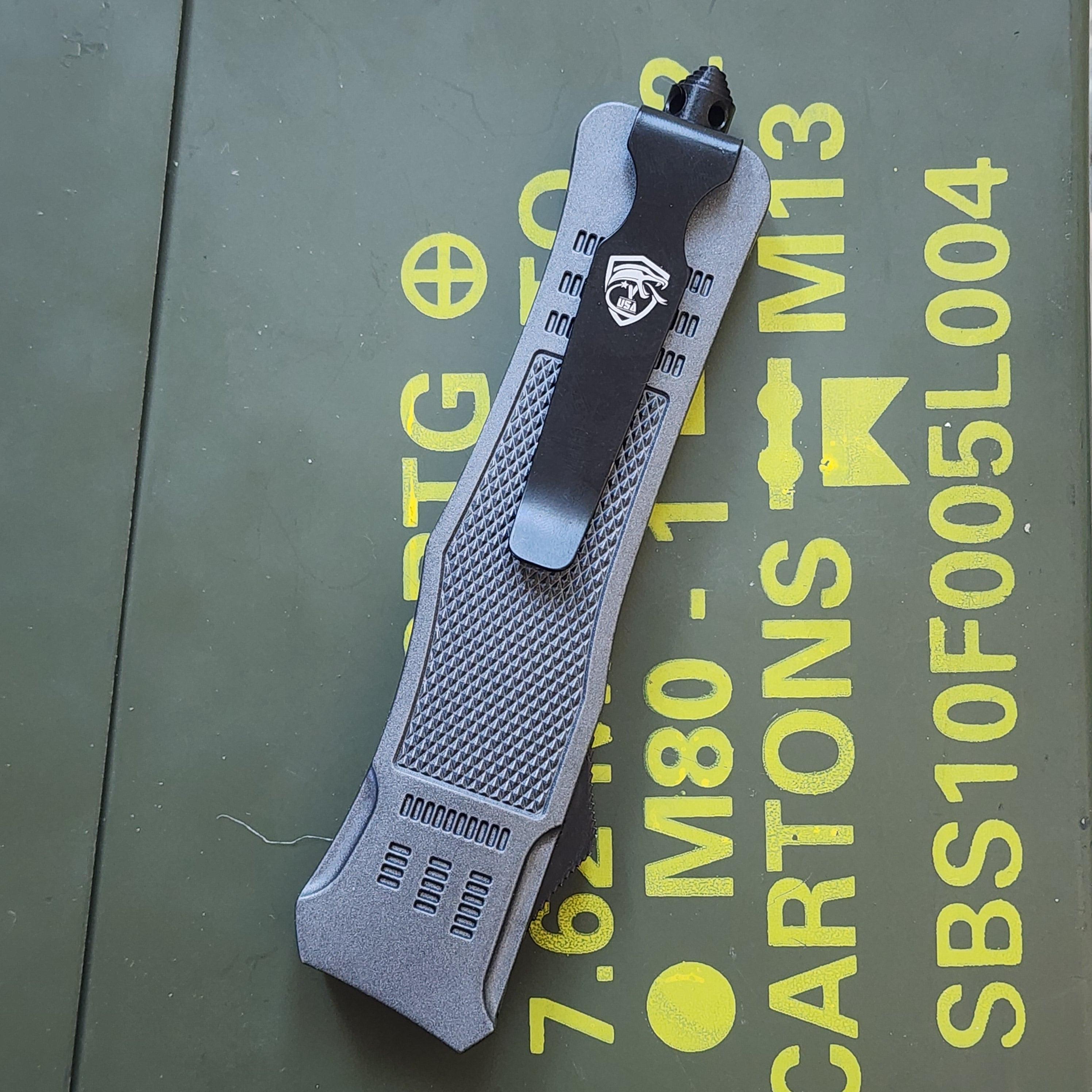 Gray tactical grip on a green background with yellow text