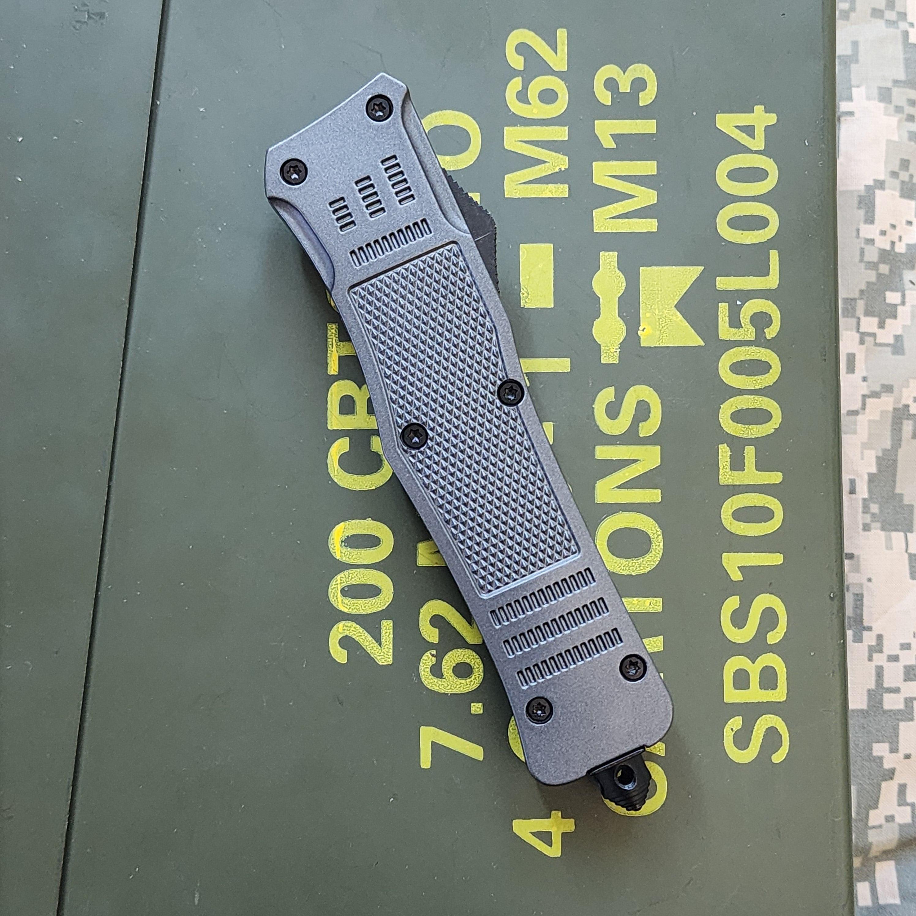 Folding knife on a green surface with text and symbols