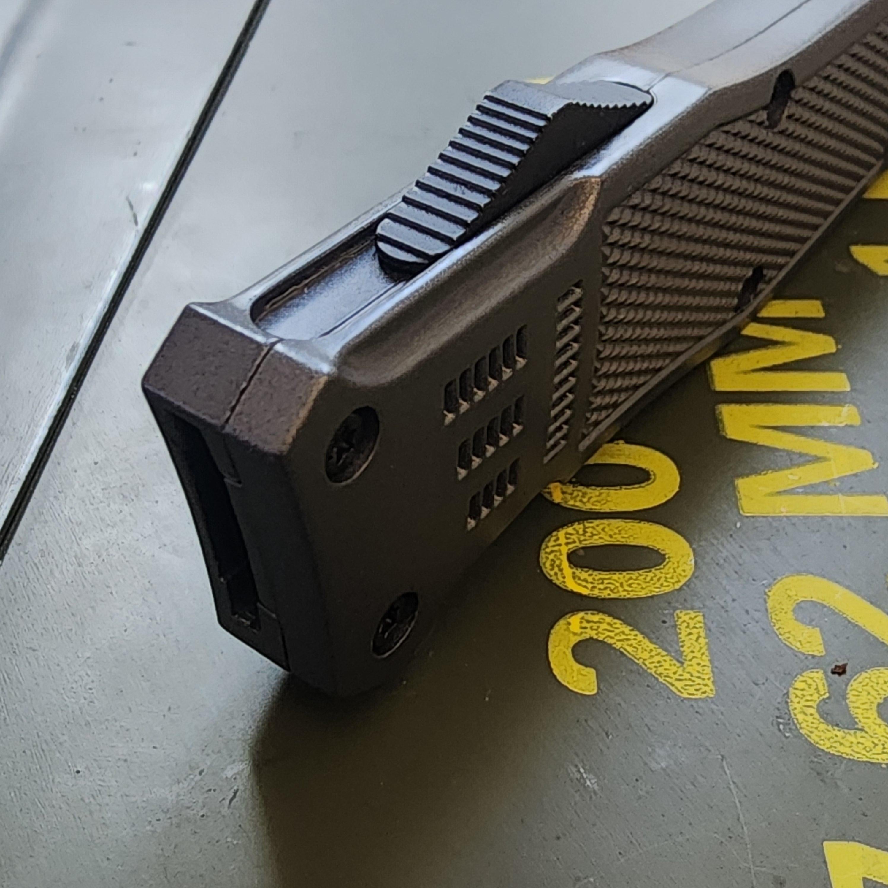 Close-up of a gun grip with yellow text in the background