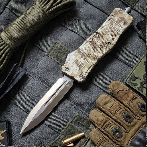 Camouflage pocket knife on tactical gear with gloves and ammunition.