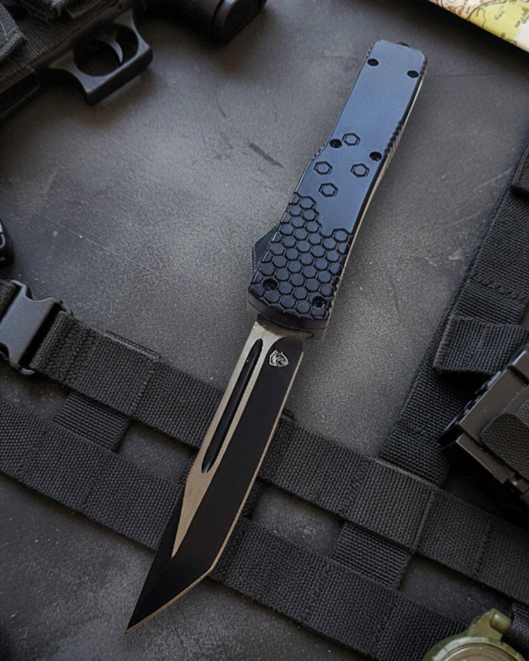 Automatic OTF knife with black and gold design on a tactical background