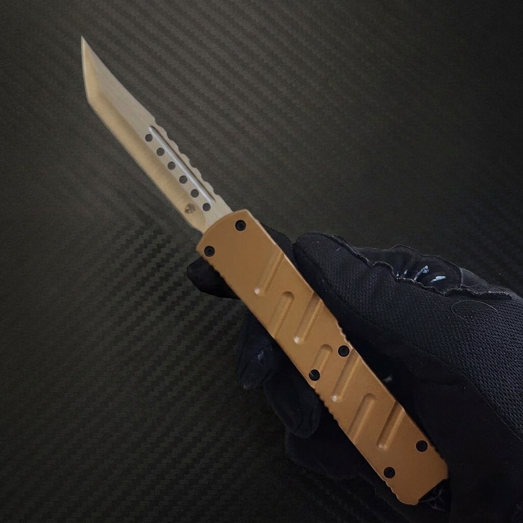 Knife with a brown handle and silver blade held by a gloved hand on a dark textured background